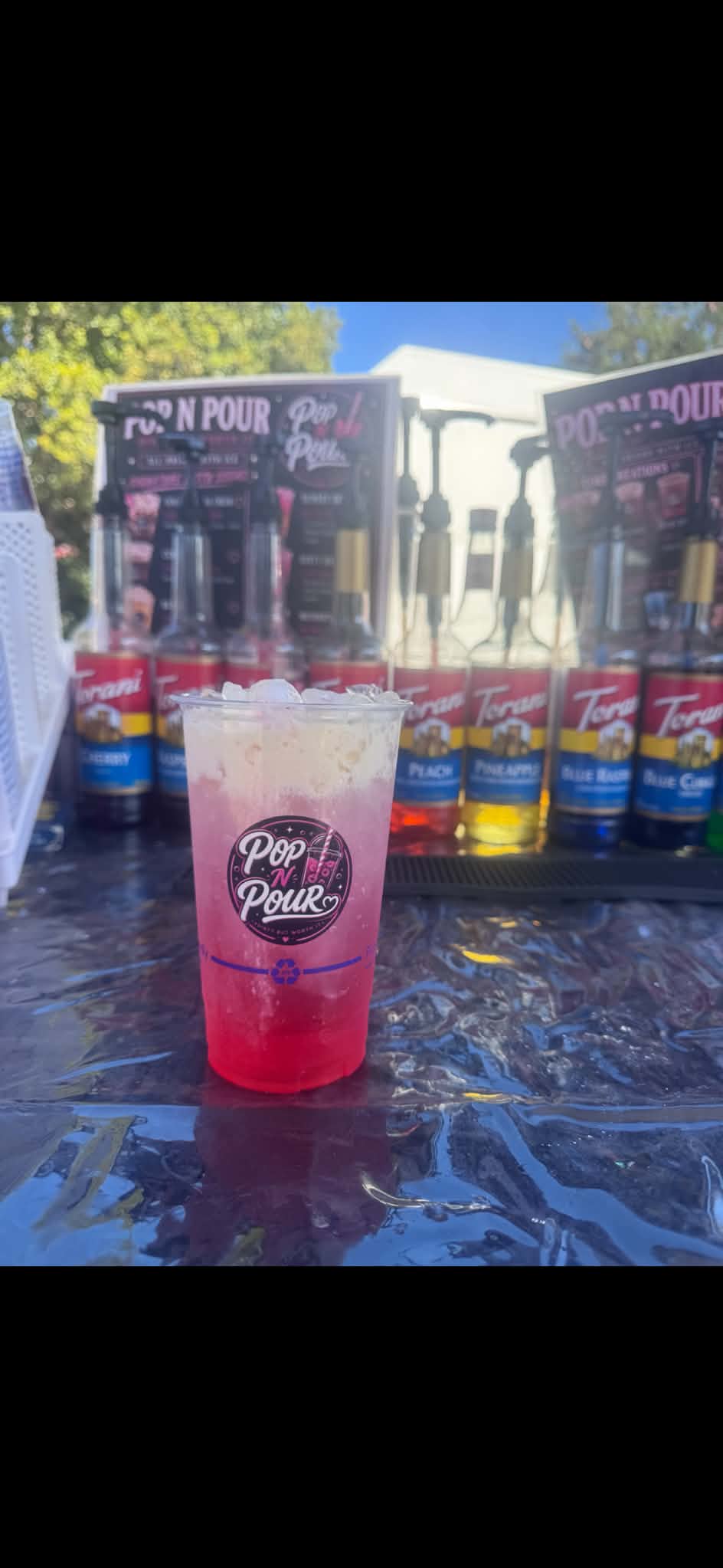 A pink Pop N Pour soda topped with creamy foam