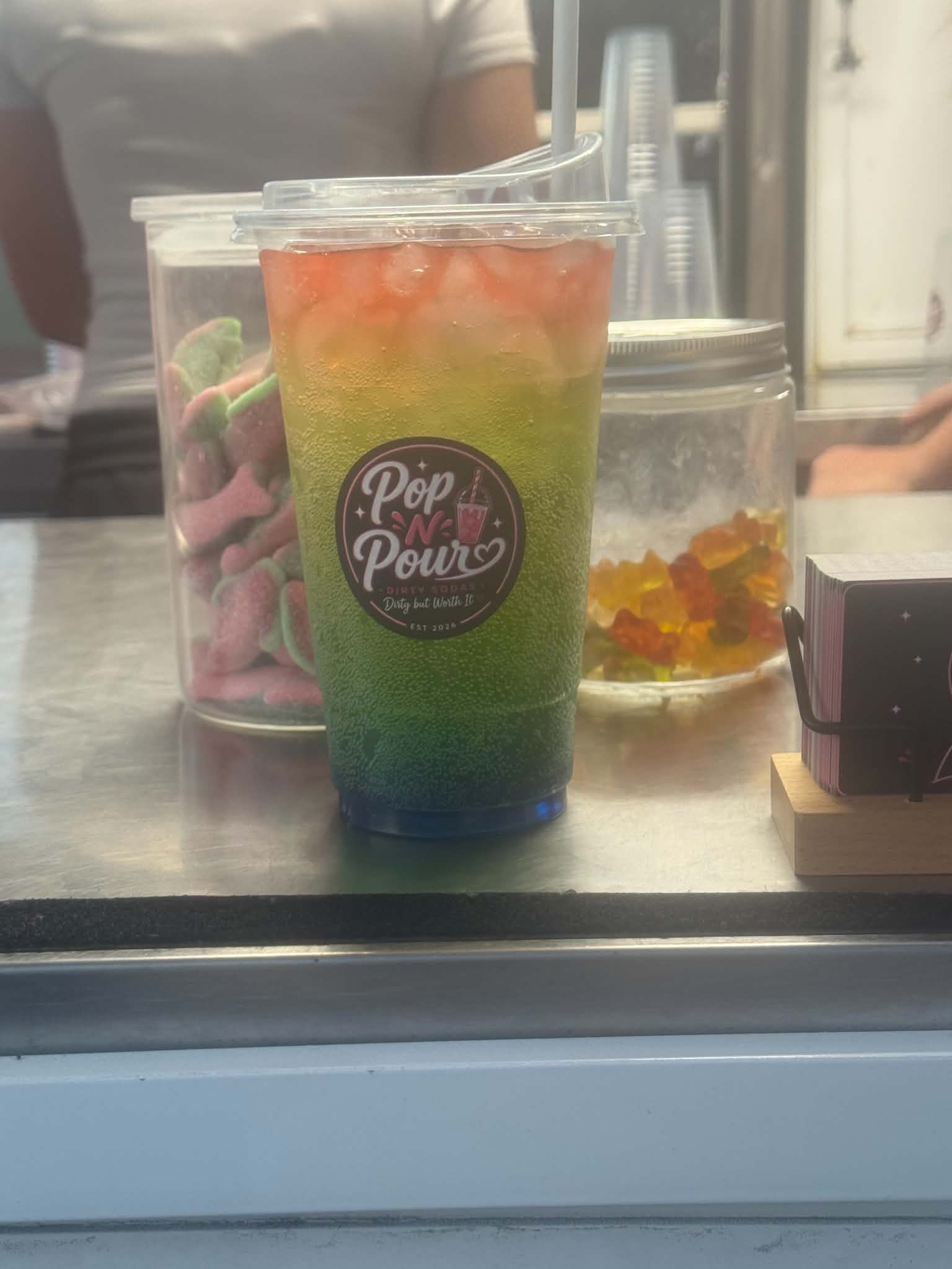 A layered green, yellow and pink Pop N Pour soda